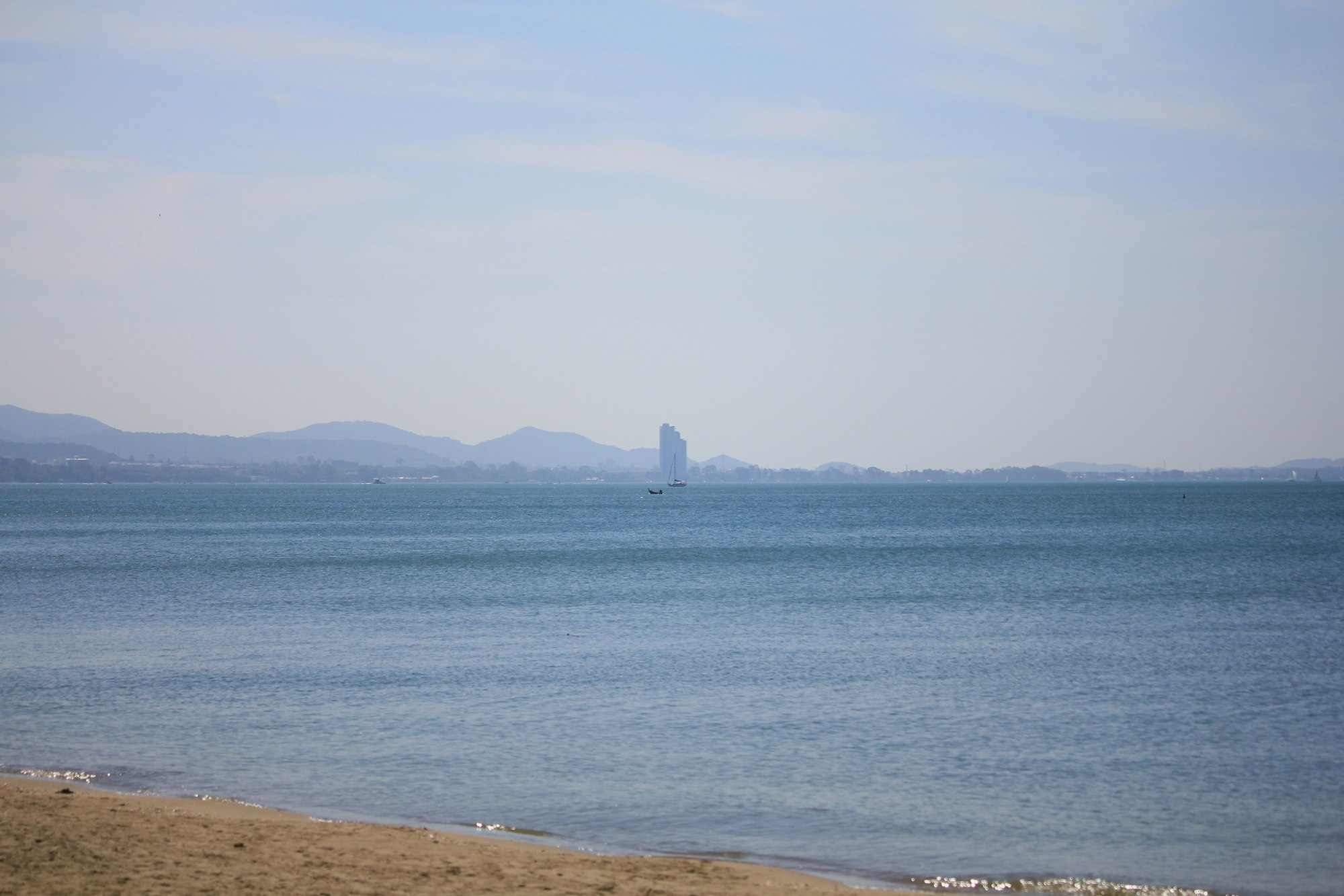 Jomtien Beach with palm trees and blue water